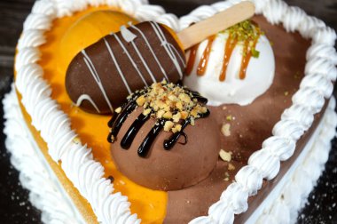 Dondurma ve çeşitli aromalı dondurmalar. Dondurma ve krema içinde kek katmanı olan çeşitli tatlar. Üzerinde karamel sosu olan mango, vanilya ve çikolata.