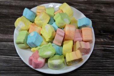 Marshmallows, marshmallow is a confectionery made from sugar, water and gelatin whipped to a solid-but-soft consistency, its naming comes from mallow plant species (Althaea officinalis), pile of candy