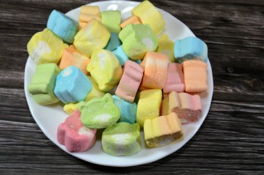 Marshmallows, marshmallow is a confectionery made from sugar, water and gelatin whipped to a solid-but-soft consistency, its naming comes from mallow plant species (Althaea officinalis), pile of candy