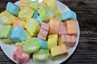 Marshmallows, marshmallow is a confectionery made from sugar, water and gelatin whipped to a solid-but-soft consistency, its naming comes from mallow plant species (Althaea officinalis), pile of candy