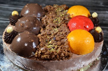 Dondurmalı pasta, üzerinde çikolata topu ve krema, karamel sosu, fındıklı çikolata parçaları, fındık, mango ve çilek topları, yaz ve tatil konsepti.