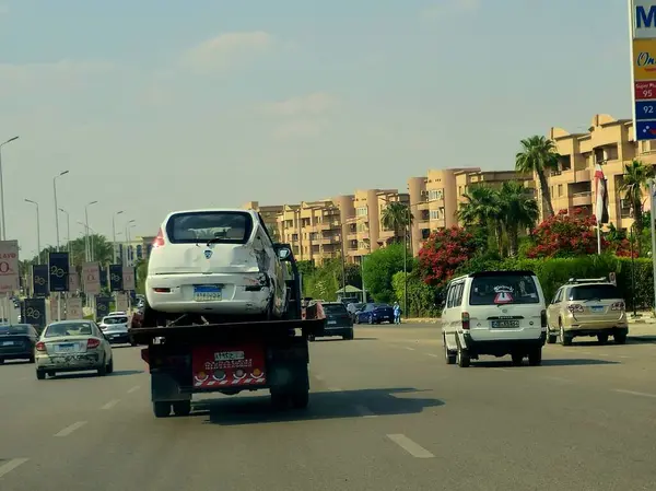 Kahire, Mısır, 30 Mayıs 2025: Çekici kurtarma taşıyıcısı hidrolik kamyon bozuk bir arabayı kaldırıyor, bakım hizmetleri için sokaktan bir arabayı kurtarıyor