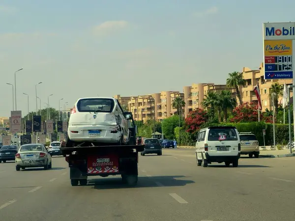 Kahire, Mısır, 30 Mayıs 2025: Çekici kurtarma taşıyıcısı hidrolik kamyon bozuk bir arabayı kaldırıyor, bakım hizmetleri için sokaktan bir arabayı kurtarıyor