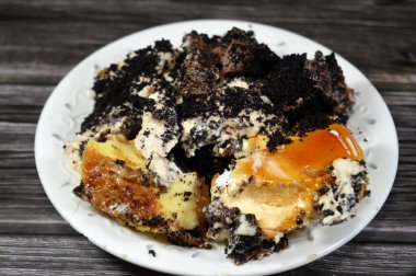 Bir tabak dolusu peynirli kek ile samur bisküvisi Fransız kurabiyesi kremalı çikolata ve bisküvi kremalı pasta, kremalı krema, çikolata soslu, sütlü kek.