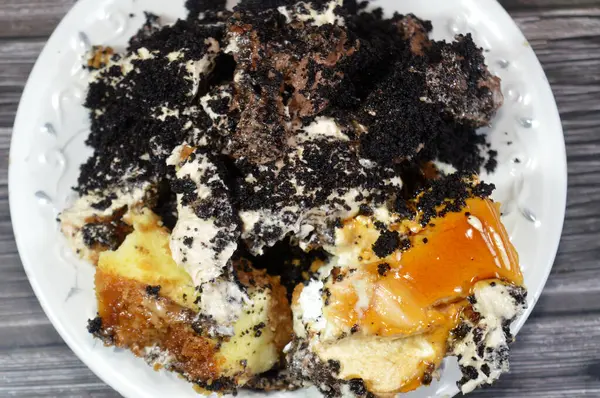 Bir tabak dolusu peynirli kek ile samur bisküvisi Fransız kurabiyesi kremalı çikolata ve bisküvi kremalı pasta, kremalı krema, çikolata soslu, sütlü kek.