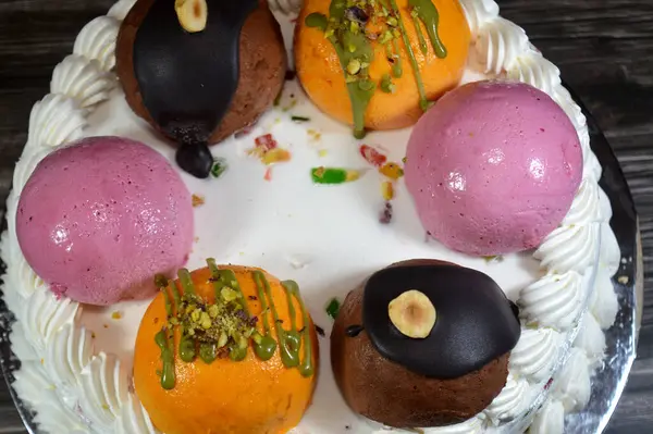 Dondurmalı pasta Cassata, vanilya, çırpılmış krema, süt, kurutulmuş meyve ile doldurulmuş mango topları, şam fıstığı parçaları ve sos, soslu çikolata topları ve fındık, böğürtlen topu.