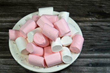Marshmallows, marshmallow is a confectionery made from sugar, water and gelatin whipped to a solid-but-soft consistency, its naming comes from mallow plant species (Althaea officinalis), pile of candy