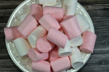 Marshmallows, marshmallow is a confectionery made from sugar, water and gelatin whipped to a solid-but-soft consistency, its naming comes from mallow plant species (Althaea officinalis), pile of candy