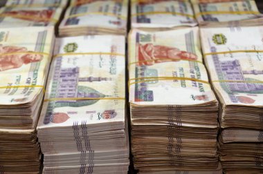 Stacks and piles of Egypt money thousands of Pounds currency banknotes bills of 200 EGP LE, Egyptian money exchange rate and economy status, money concept, inflation crisis, currency and investment