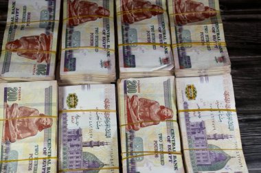 Stacks and piles of Egypt money thousands of Pounds currency banknotes bills of 200 EGP LE, Egyptian money exchange rate and economy status, money concept, inflation crisis, currency and investment