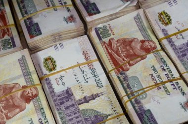 Stacks and piles of Egypt money thousands of Pounds currency banknotes bills of 200 EGP LE, Egyptian money exchange rate and economy status, money concept, inflation crisis, currency and investment