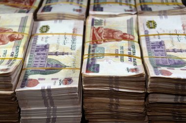 Stacks and piles of Egypt money thousands of Pounds currency banknotes bills of 200 EGP LE, Egyptian money exchange rate and economy status, money concept, inflation crisis, currency and investment