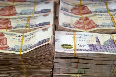 Stacks and piles of Egypt money thousands of Pounds currency banknotes bills of 200 EGP LE, Egyptian money exchange rate and economy status, money concept, inflation crisis, currency and investment