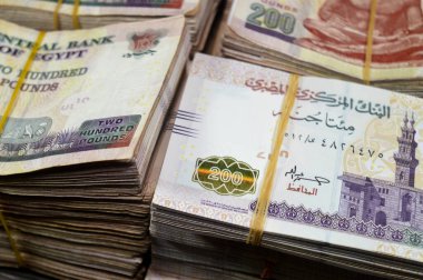 Stacks and piles of Egypt money thousands of Pounds currency banknotes bills of 200 EGP LE, Egyptian money exchange rate and economy status, money concept, inflation crisis, currency and investment