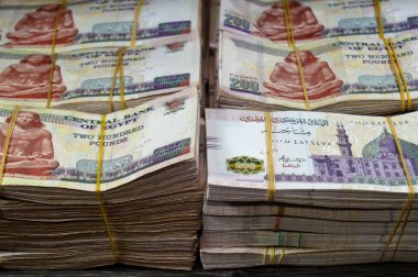 Stacks and piles of Egypt money thousands of Pounds currency banknotes bills of 200 EGP LE, Egyptian money exchange rate and economy status, money concept, inflation crisis, currency and investment