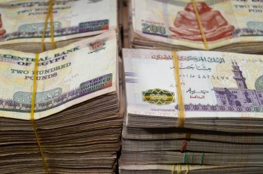Stacks and piles of Egypt money thousands of Pounds currency banknotes bills of 200 EGP LE, Egyptian money exchange rate and economy status, money concept, inflation crisis, currency and investment