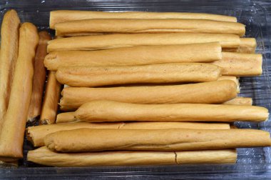 Breadsticks, also known as grissini, grissino or dipping sticks, pencil-sized sticks of crisp, dry baked bread, There is also a soft-baked breadstick version, rusk, bread crunch crackers