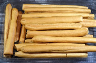 Breadsticks, also known as grissini, grissino or dipping sticks, pencil-sized sticks of crisp, dry baked bread, There is also a soft-baked breadstick version, rusk, bread crunch crackers