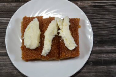 Basbosa kremalı kremalı süt pıhtılaştırılmış süt ve bal şekerli şurupla doymuş, Basbusa genellikle Ramazan ayında pişirilen bir orta doğu tatlısıdır.