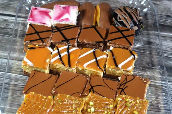 Farklı soslu çeşitli küçük Gateaux, Gateau ısırıkları, çeşitli pasta aromalı ve dolgulu, minyatür kekler, ekler, mili feille ve sünger kekten yapılmış küçük lokma büyüklüğünde pastalardır.