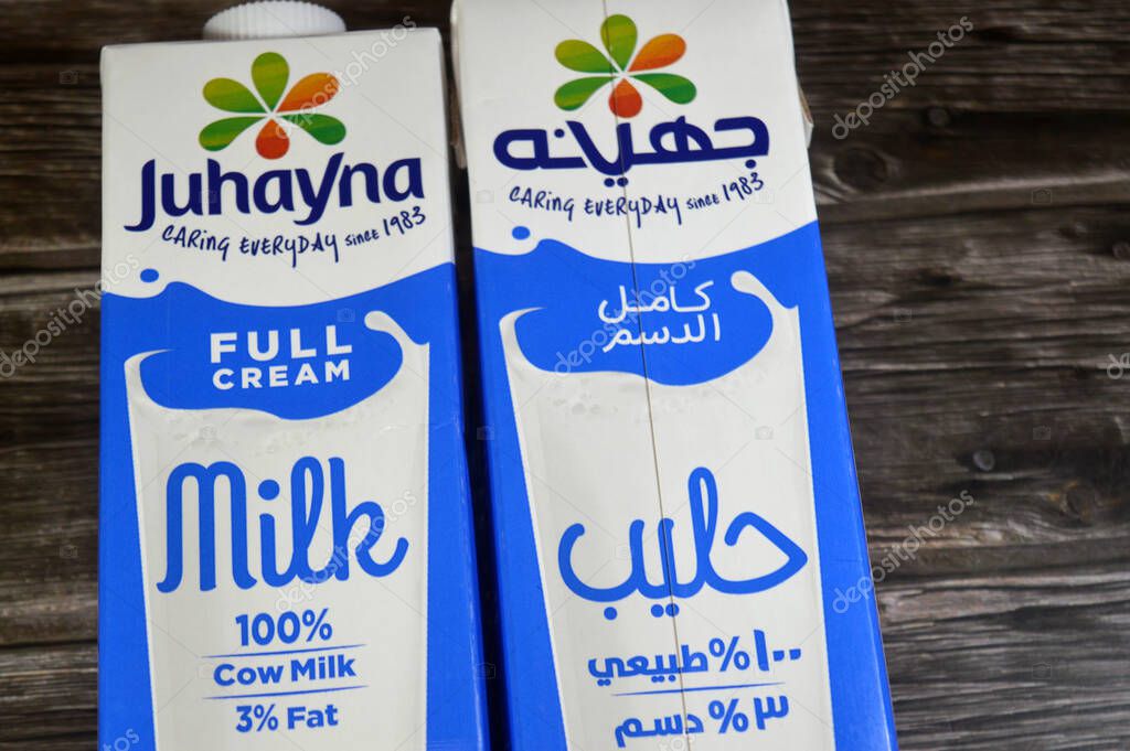 Cairo, Egypt, October 2 2025: Juhayna full cream fresh cow's milk carton bottle of 1 Liter litres with Calcium and vitamins, selective focus of Johayna natural milk on wooden background
