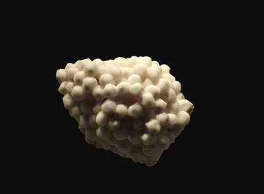 A close-up view of an aragonite mineral specimen showcasing its white, spherical formations on a dark background clipart