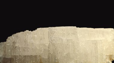 A close-up view of a Beryllonite mineral specimen showcasing its prismatic, translucent to transparent, pale yellowish crystals on a dark background clipart