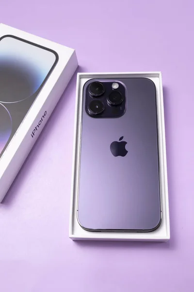 Stock image Deep Purple colored iPhone 14 Pro with features Always-on display, 48-megapixel Main camera, Dynamic Island. Purple background. Vertical plane. New smartphone. Bialystok, Poland: January 20,2023. 