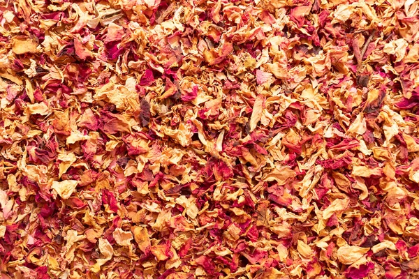 Texture dried rose petals, leaves. Potpourri, desiccated rose buds background. Top view aromatic herbal beverage made from fragrant flowers. Horizontal from above, space for text. High quality photo