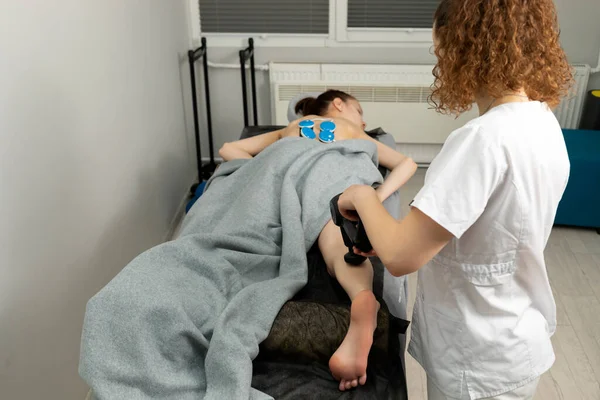 Rehabilitation Specialist, Physical Therapist Makes Leg Massage To Child With Cerebral Palsy, Scoliosis. Health Specialist, Rehabilitation. Horizontal plane. High quality photo