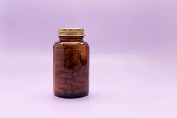 Brown Glass Bottle Softgel Capsules Slippery Elm Purple Violet Background — Stock Photo, Image
