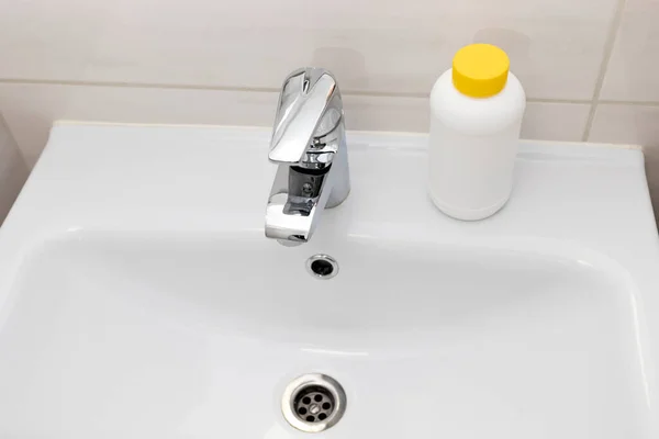 Υδραυλικοί Κόκκοι Αποχέτευσης Λευκό Πλαστικό Μπουκάλι Κίτρινο Καπάκι Στο Μπάνιο — Φωτογραφία Αρχείου