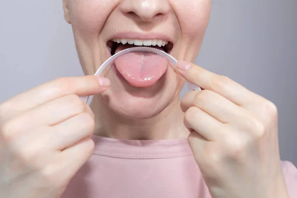 stock image Closeup Of Woman Cleaning Her Tongue With Plastic Flexible Tongue Scraper, Cleaner. Dentistry, dental care concept Horizontal Plane. Selective Focus. High quality photo