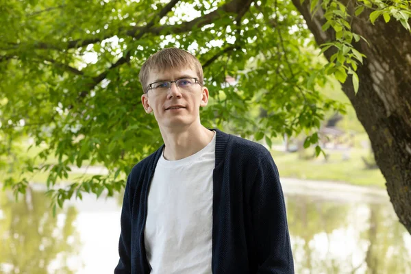 stock image Portrait Of Tall Blond 40 Yo Man In Eyesight Glasses, Smiling Looking At Camera, Green Tree And Lake On Background. Horizontal Plane. High quality photo