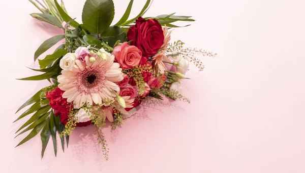 Real Beautiful Fresh Bouquet Of Flowers On Pink Background. Colorful Mixed Roses, Carnation Shabot, Green Leaves, Gerber. Horizontal Plane, Copy Space For Text.