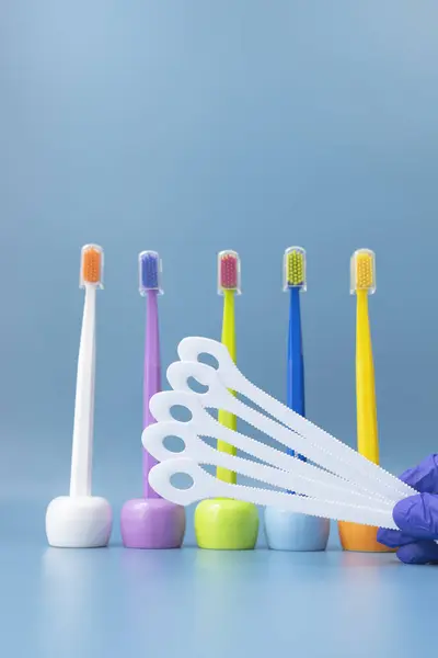 Large Number Cleaning Tongue Scrapers Multicolored Toothbrushes Blue Background Morning — Stock Photo, Image