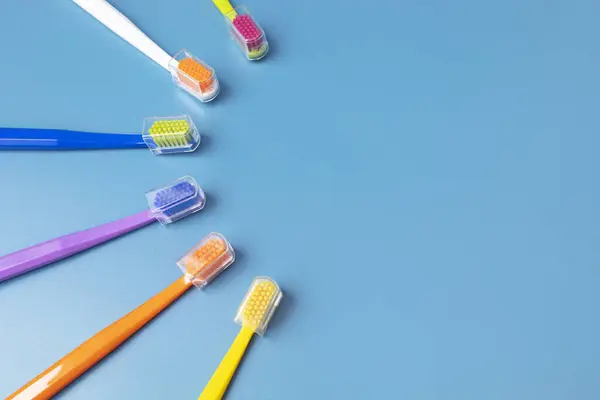 Flat Lay Few Multicolored Toothbrushes Lying Shape Sun Blue Background — Stock Photo, Image