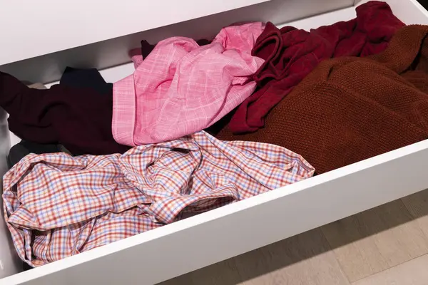 Messy Drawer With Dangling Unfolded Mans Clothes, Scattered Things, Junk Drawer. Organizing Wardrobe, Closet. Clean That Mess Concept, Organize Your Dresser, Storage Solutions, Horizontal Plane.