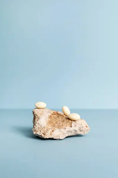 stock image Progesterone Capsules On Stone, Blue Background. Natural Product Concept. Mockup Menopausal Hormone Therapy, Oral Route. Menopause. Cycle Changes. Vertical Copy Space. Design. High quality photo