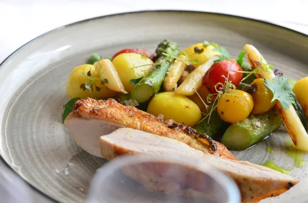 grilled chicken breast with vegetable side dish, served food in a restaurant on a plate
