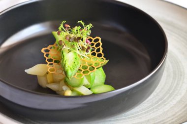 kuşkonmaz salatası yeşil ve beyaz kuşkonmaz siyah kasede, sağlıklı yiyecekler.