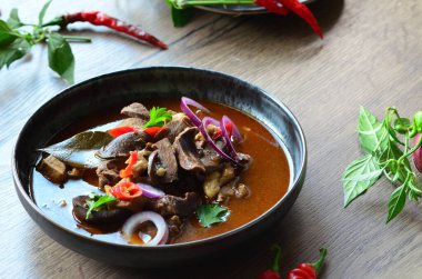 Gulaş, karaciğer, omuz ve kalp parçalı yahni, geleneksel Çek kasabı kebabı, tahta bir masada siyah bir tabakta yemek servisi, yiyecek arka planı, yakın görüş.