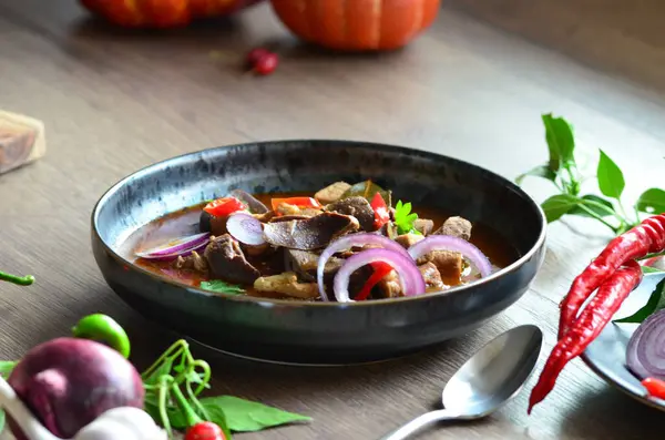 traditional Czech dish pork stew, served in a black plate, with ingredients