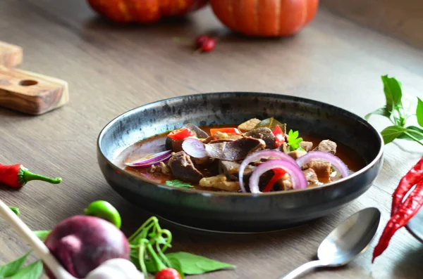 traditional Czech dish pork stew, served in a black plate, with ingredients