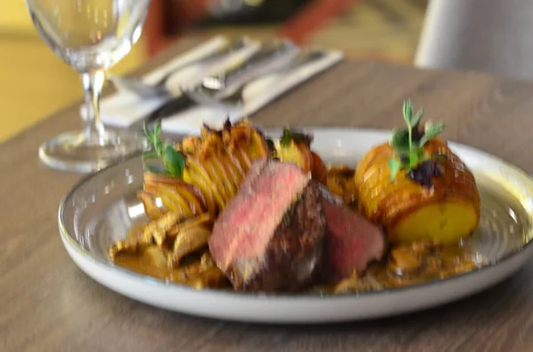 served steak in a restaurant on a plate, close up view, potatoe