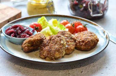 Salata ve patatesli tavuk pirzolası.