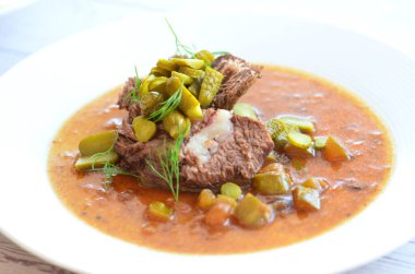 Sığır eti yahnisi, salatalık sosu, ekmek köftesi, geleneksel Çek mutfağı, hafif arka planda servis edilen yiyeceklerin arka planı.