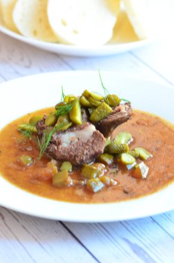 Sığır eti yahnisi, salatalık sosu, ekmek köftesi, geleneksel Çek mutfağı, hafif arka planda servis edilen yiyeceklerin arka planı.