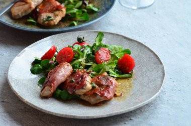 Kırsal bir tabakta servis edilen yemeğin güzel arka planı, İtalyan mutfağı, dana eti saltimbocka, karışık salata, yakın görüş.,