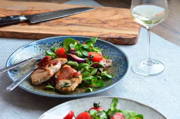 Kırsal bir tabakta servis edilen yemeğin güzel arka planı, İtalyan mutfağı, dana eti saltimbocka, karışık salata, yakın görüş.,